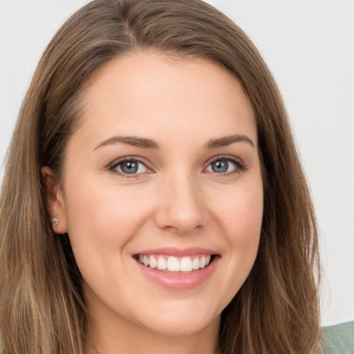 Joyful white young-adult female with long  brown hair and green eyes