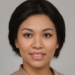 Joyful asian young-adult female with medium  black hair and brown eyes