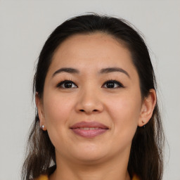 Joyful latino young-adult female with medium  brown hair and brown eyes