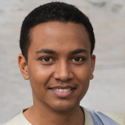 Joyful black young-adult male with short  brown hair and brown eyes