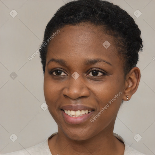 Joyful black young-adult female with short  brown hair and brown eyes