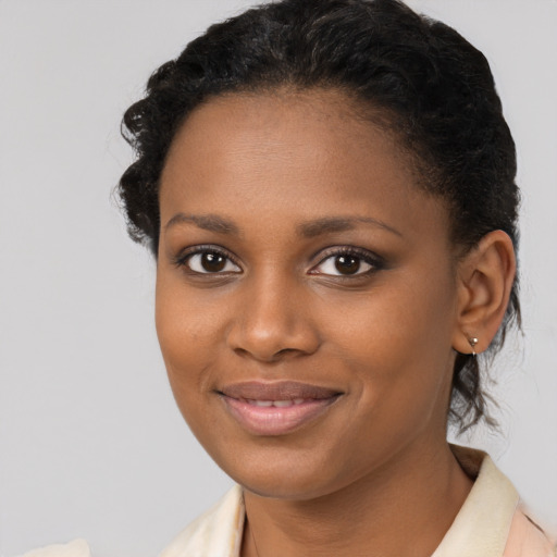 Joyful black young-adult female with short  brown hair and brown eyes