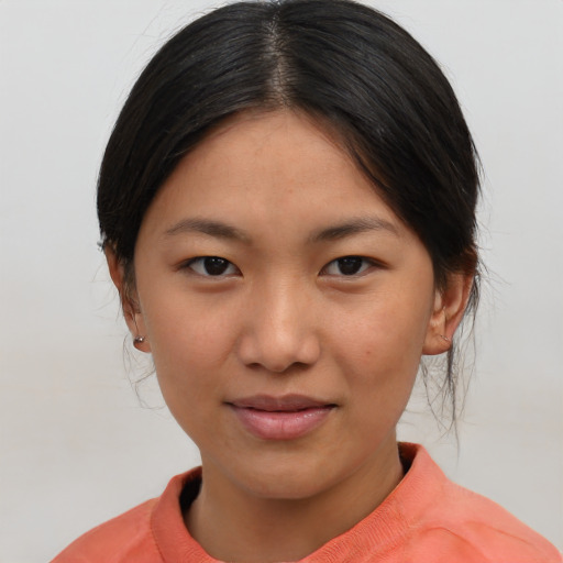 Joyful asian young-adult female with medium  brown hair and brown eyes