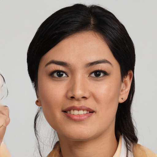 Joyful latino young-adult female with medium  black hair and brown eyes