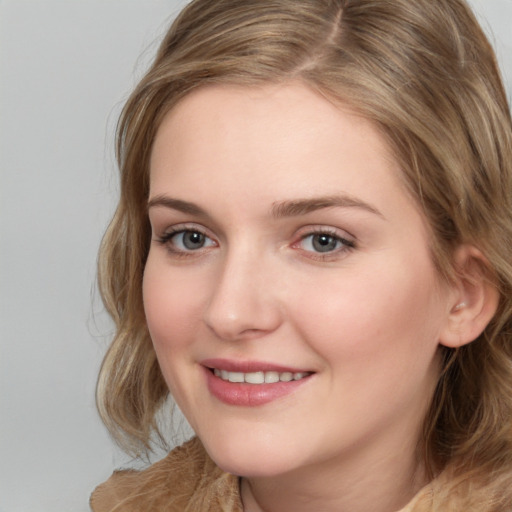 Joyful white young-adult female with medium  brown hair and blue eyes