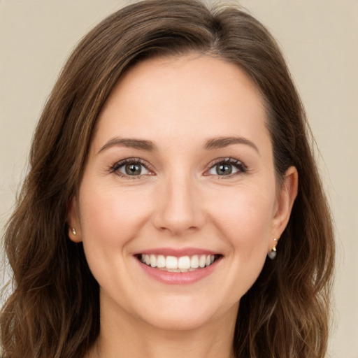 Joyful white young-adult female with long  brown hair and green eyes