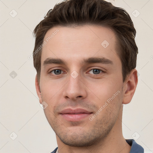 Joyful white young-adult male with short  brown hair and grey eyes