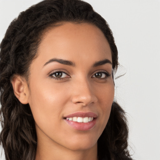 Joyful latino young-adult female with long  brown hair and brown eyes