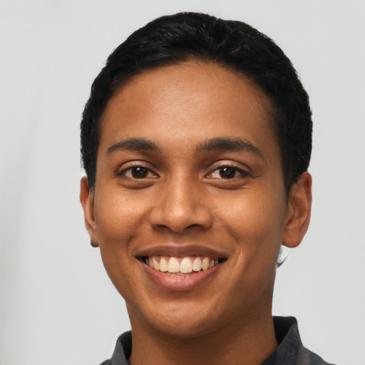 Joyful latino young-adult male with short  black hair and brown eyes