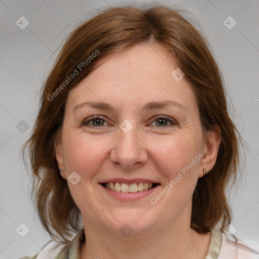 Joyful white adult female with medium  brown hair and grey eyes