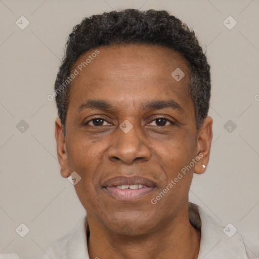 Joyful black adult male with short  black hair and brown eyes