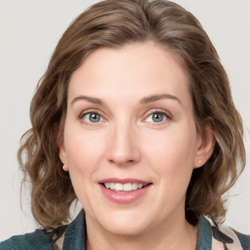 Joyful white young-adult female with medium  brown hair and blue eyes