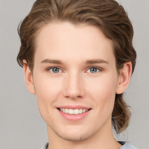 Joyful white young-adult female with short  brown hair and green eyes