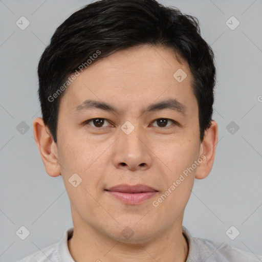 Joyful asian young-adult male with short  brown hair and brown eyes