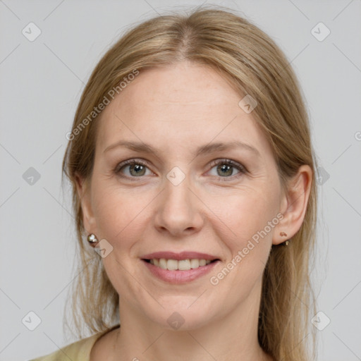 Joyful white adult female with medium  brown hair and grey eyes