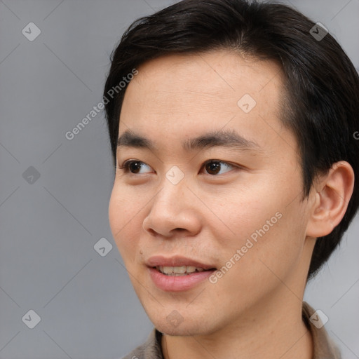 Joyful asian young-adult male with short  brown hair and brown eyes