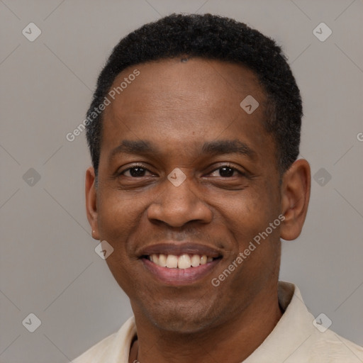 Joyful black young-adult male with short  black hair and brown eyes