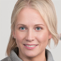 Joyful white young-adult female with medium  brown hair and blue eyes