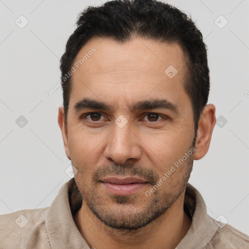 Joyful white young-adult male with short  black hair and brown eyes