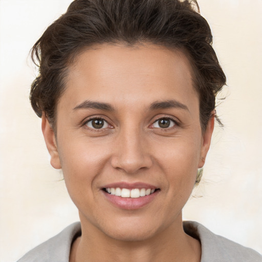 Joyful white young-adult female with short  brown hair and brown eyes