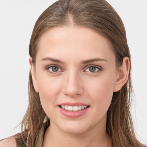 Joyful white young-adult female with long  brown hair and grey eyes