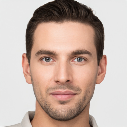 Joyful white young-adult male with short  brown hair and brown eyes