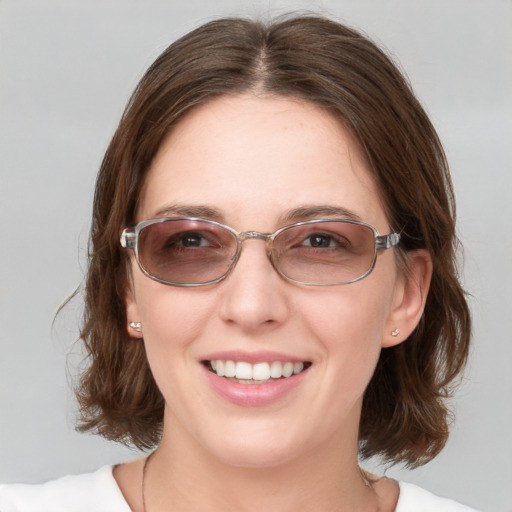 Joyful white young-adult female with medium  brown hair and blue eyes