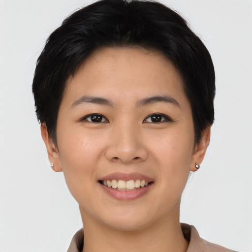 Joyful asian young-adult female with short  black hair and brown eyes