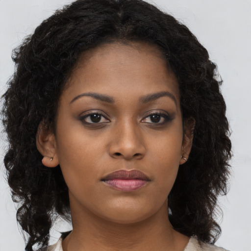 Neutral black young-adult female with long  brown hair and brown eyes