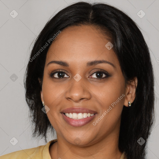 Joyful black young-adult female with long  brown hair and brown eyes