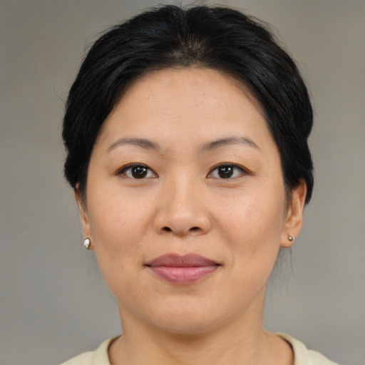 Joyful asian adult female with short  brown hair and brown eyes