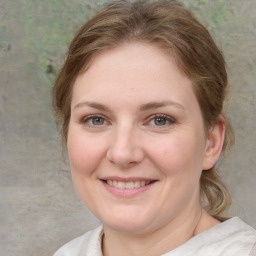 Joyful white young-adult female with medium  brown hair and blue eyes