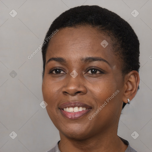 Joyful black young-adult female with short  brown hair and brown eyes