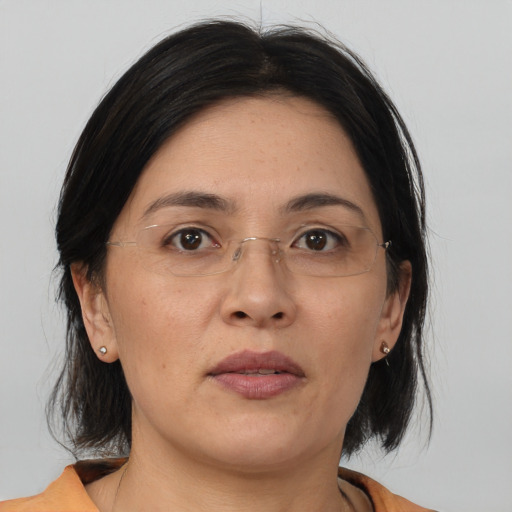 Joyful asian adult female with medium  brown hair and brown eyes