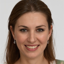 Joyful white young-adult female with long  brown hair and grey eyes