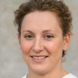 Joyful white adult female with medium  brown hair and grey eyes