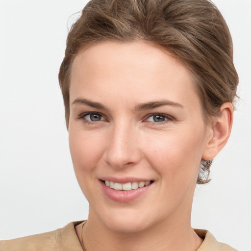 Joyful white young-adult female with short  brown hair and grey eyes