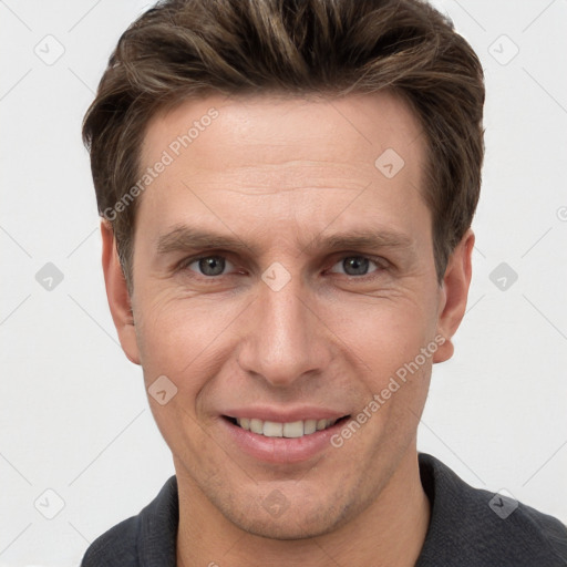 Joyful white adult male with short  brown hair and grey eyes