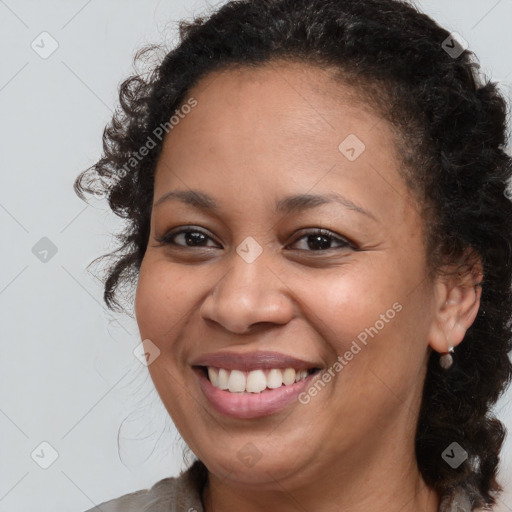 Joyful black young-adult female with medium  brown hair and brown eyes