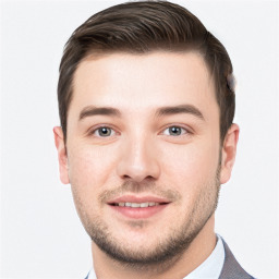 Joyful white young-adult male with short  brown hair and grey eyes