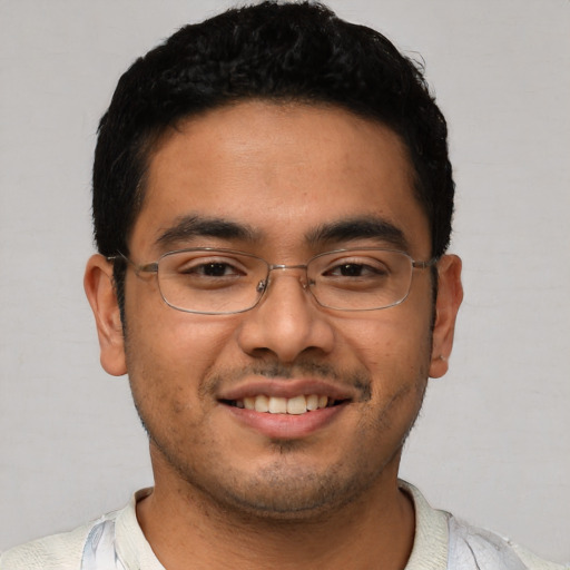 Joyful latino young-adult male with short  black hair and brown eyes