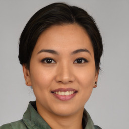 Joyful asian young-adult female with medium  brown hair and brown eyes