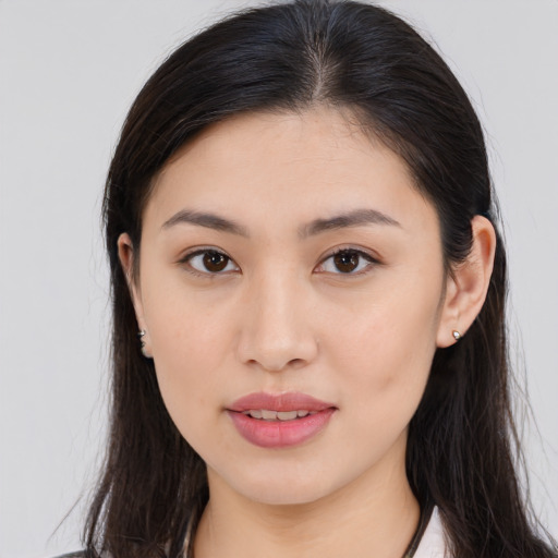 Joyful asian young-adult female with long  brown hair and brown eyes