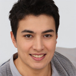 Joyful latino young-adult male with short  brown hair and brown eyes