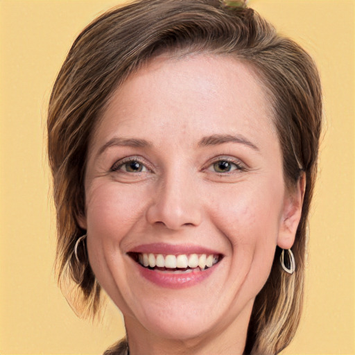 Joyful white adult female with medium  brown hair and green eyes