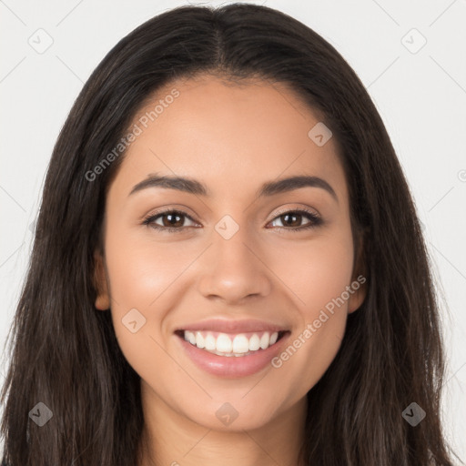 Joyful latino young-adult female with long  brown hair and brown eyes