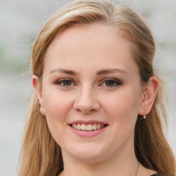 Joyful white young-adult female with medium  brown hair and blue eyes