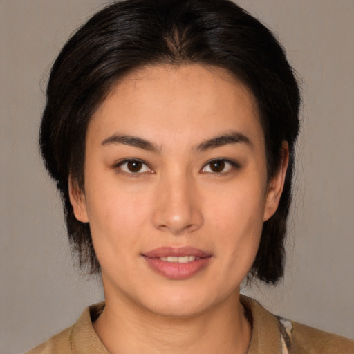 Joyful white young-adult female with medium  brown hair and brown eyes