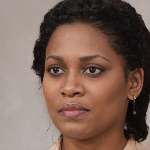 Joyful black young-adult female with medium  brown hair and brown eyes