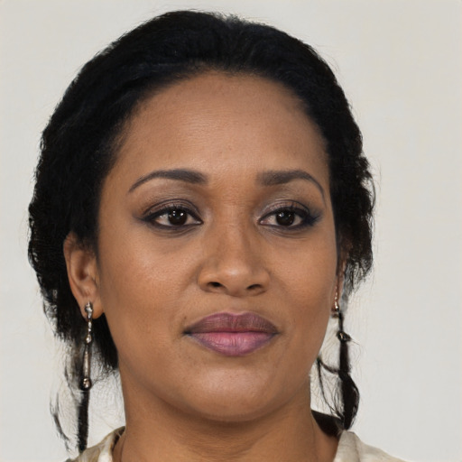 Joyful black adult female with medium  black hair and brown eyes